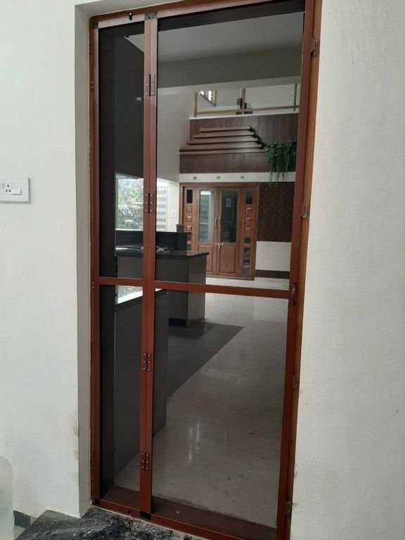 Brown aluminium mesh door at a home entrance