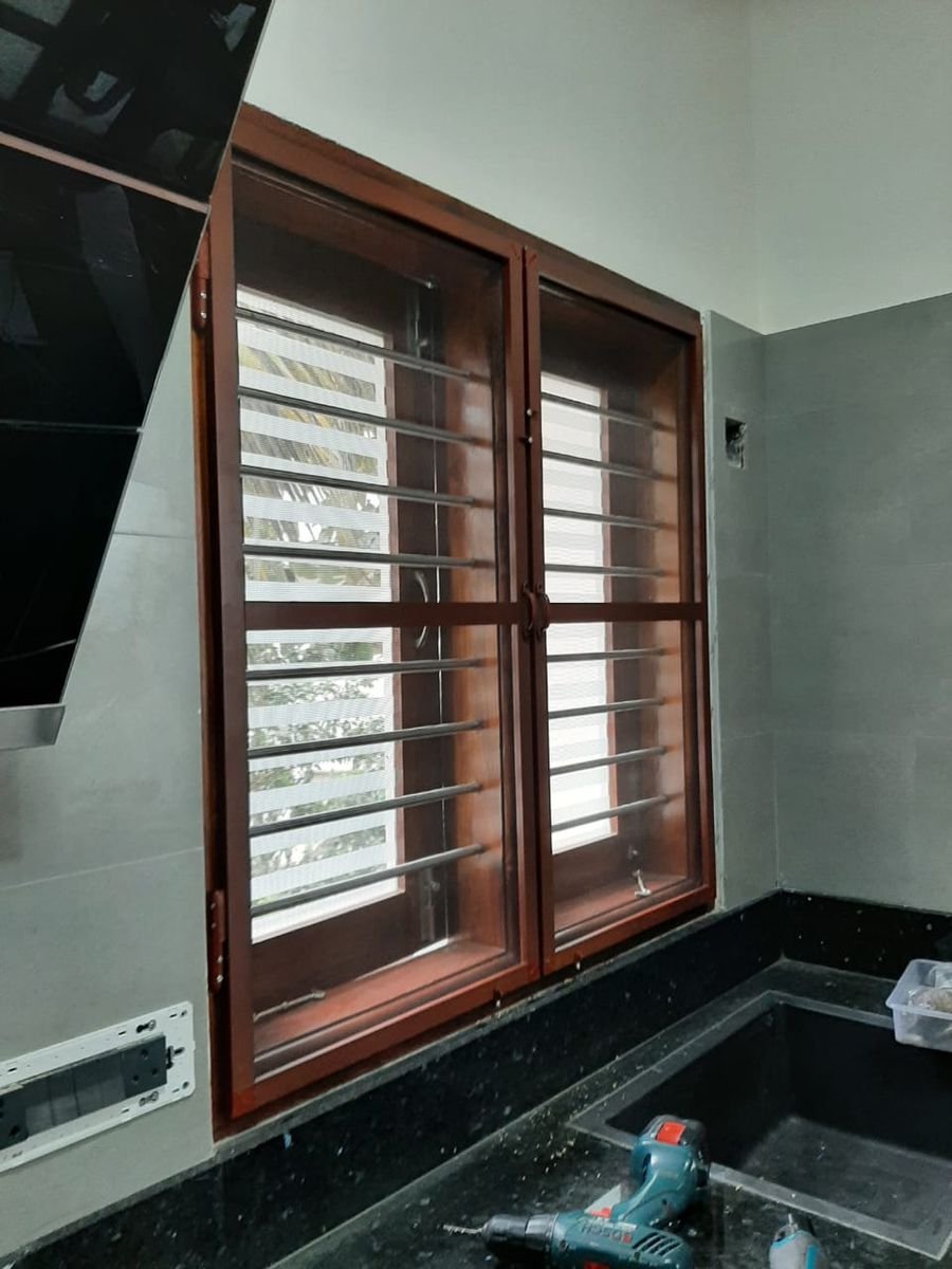 Brown aluminium section with fiberglass mesh on a kitchen window