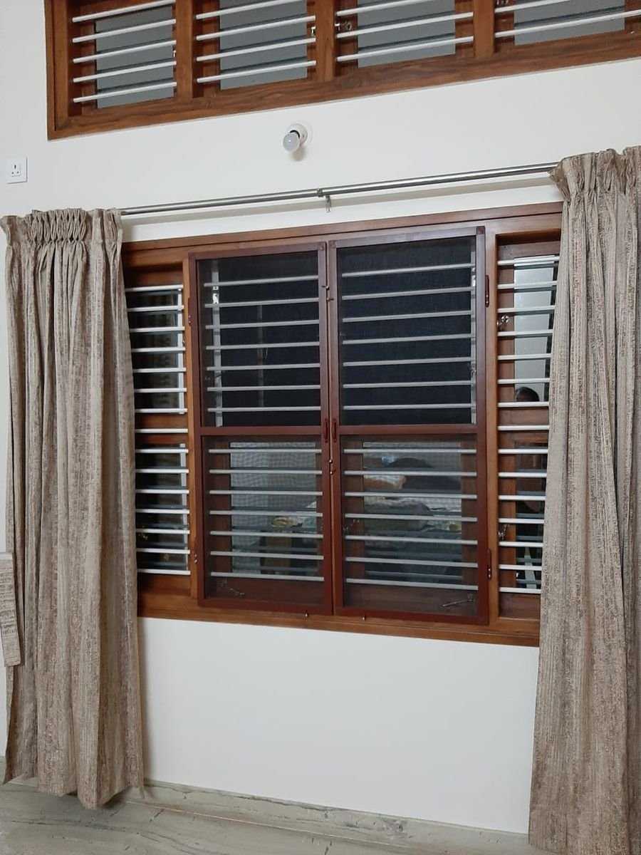 Brown aluminium section on a window with a ventilator above