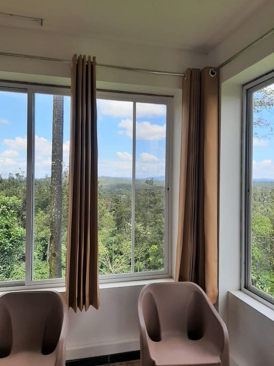 Mesh-screened corner windows with a view of the hills